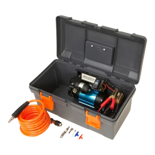 ARB single piston compressor in its grey plastic travel case with the lid open, the compressor mounted inside with its battery clamps, and the orange coiled air hose, tyre chuck and inflation adaptors laid out in front