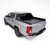 Silver pickup truck with a black tonneau cover on a white background