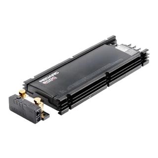 The Alpha100 R from the opposite corner, showing the depth of the extruded heatsink fins and the row of connectors along the far edge, with the sense module in the foreground