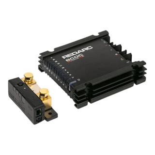 Redarc BCDC Alpha50 R battery manager at an angle with its sense module in front, the finned black case carrying the REDARC and BCDC Alpha50 R markings and the input icons down the side
