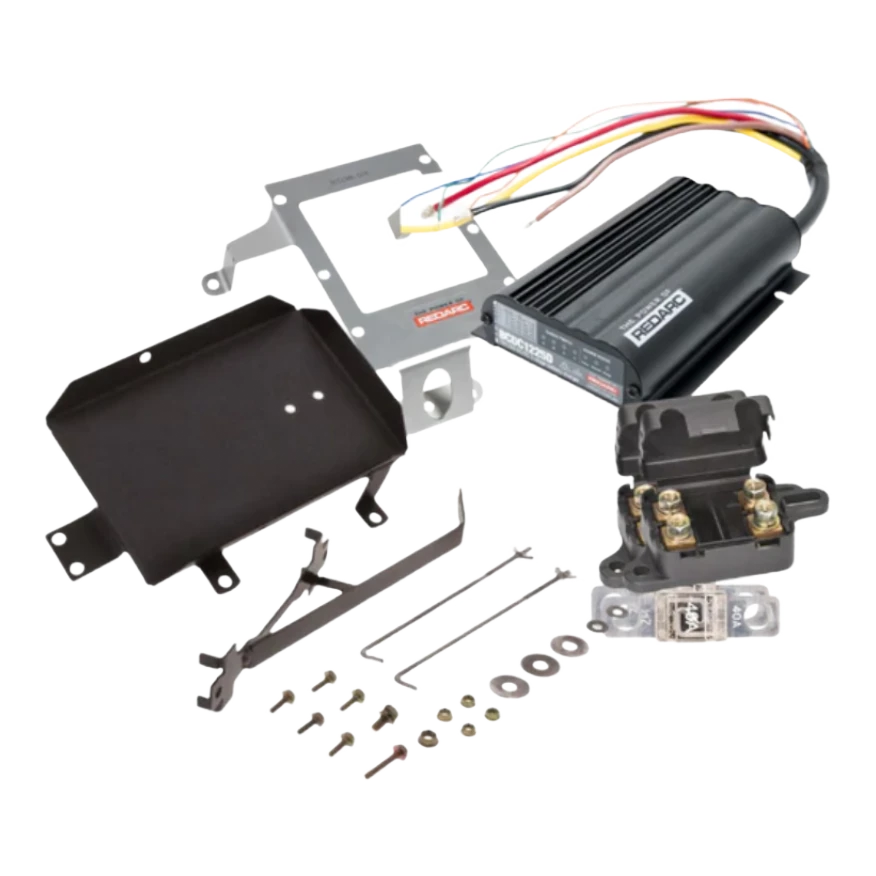 Under bonnet dual battery kit contents for the Isuzu D-MAX 3.0 turbo diesel 4JJ1-TC, showing the REDARC BCDC1225D charger, stainless bracket, battery tray, fuses and wiring