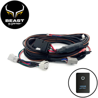 BEAST by Lightforce wiring harness coiled on white, with a relay in a black sleeve mid-loom, a multi-pin vehicle plug, two grey Deutsch lamp connectors, a white connector and battery tails, shown with the MODE touch switch inset