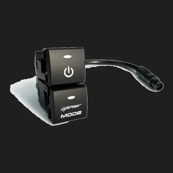The two-position Lightforce switch assembly at an angle, showing the moulded retaining clips behind each button and the short lead ending in a round multi-pin connector