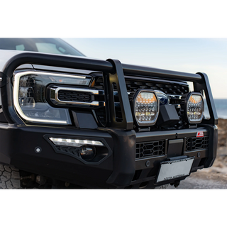 Pair of Lightforce BEAST driving lights fitted to the bullbar of a white Ford Ranger, photographed in daylight