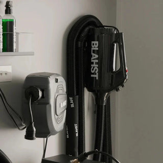 Blahst air maxx dryer and attachments mounted on a wall.
