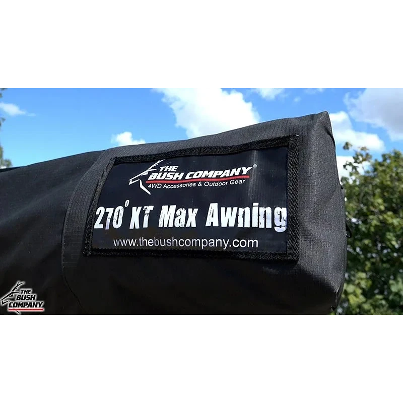Black awning with 'The Bush Company' branding against a blue sky and green trees.