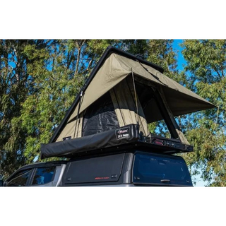 Bush Company LX27 clamshell rooftop tent open on a vehicle with trees in the background