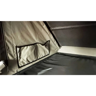 Close-up of a tent interior with a window and fabric details.
