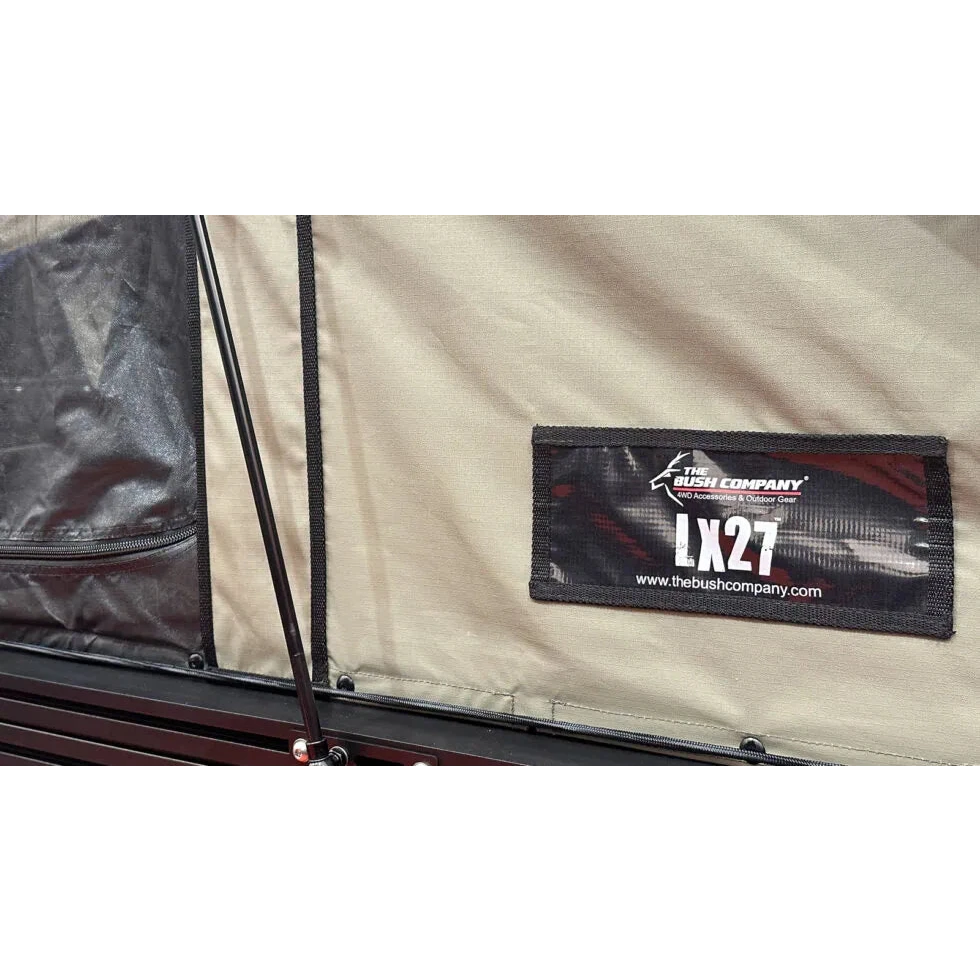 Close-up of a label on a tent with 'The Bush Company' branding and 'LX27' model number.