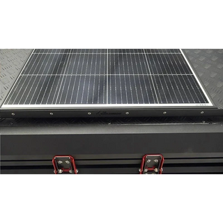 Solar panel on a bush company tent with visible brand name.