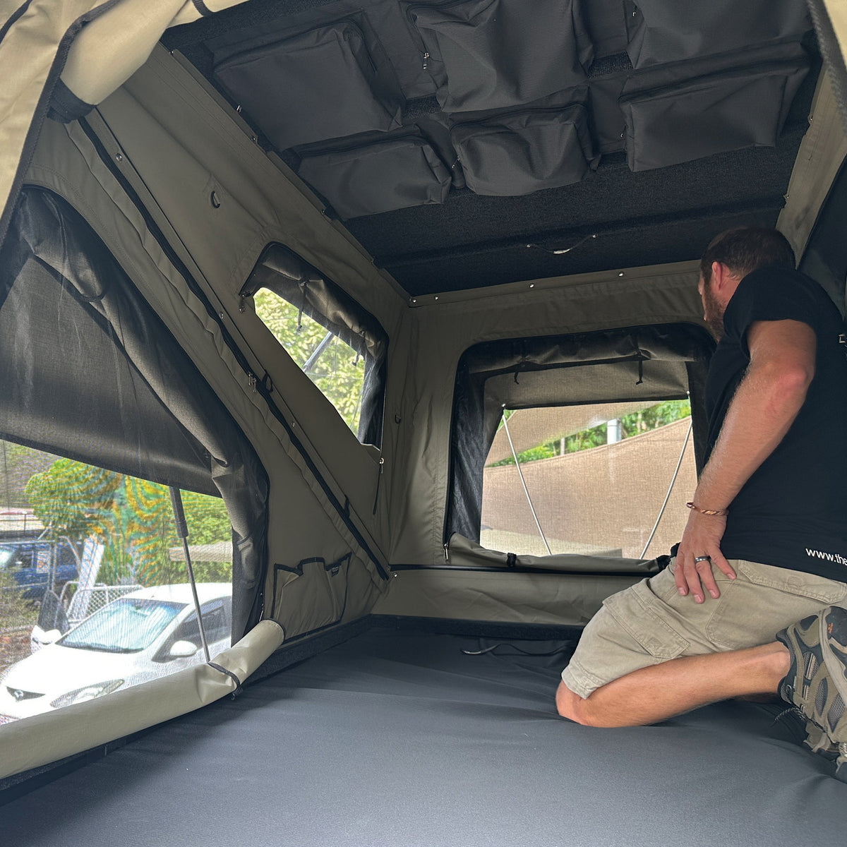 Man kneeling inside the Bush Company TX27 showing the internal headroom