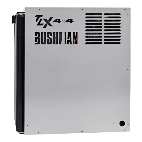 Side of a Bushman TX 4x4 fridge, the stainless panel carrying the Bushman name with the ventilation louvres and the condenser fins wrapping around the rear edge