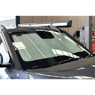 BYD Shark seen from outside with the sun shade in place behind the windscreen, reaching the full width of the glass