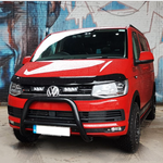 Red Volkswagen van in front of a graffiti-covered wall