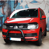 Red Volkswagen van in front of a graffiti-covered wall