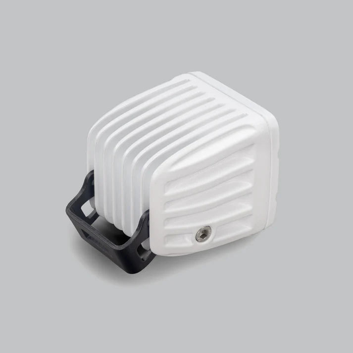 White DX4 Scene work light from behind and above, the finned white heatsink with the black bracket wrapping underneath