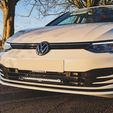 Front view of a white Volkswagen car with a clear sky and tree in the background with Lazer Lamps Grille Kit for VW Golf MK8 (2020–2024)