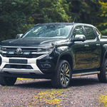 Black Volkswagen pickup truck on a dirt road with greenery in the background with Lazer Lamps Grille Kit for VW Amarok (2023+)