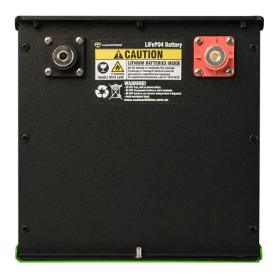 Rear face of a Custom Lithium LiFePO4 battery in a black aluminium enclosure, with a threaded negative terminal at the left, a red-shrouded positive at the right, and the caution label warning that lithium batteries are inside
