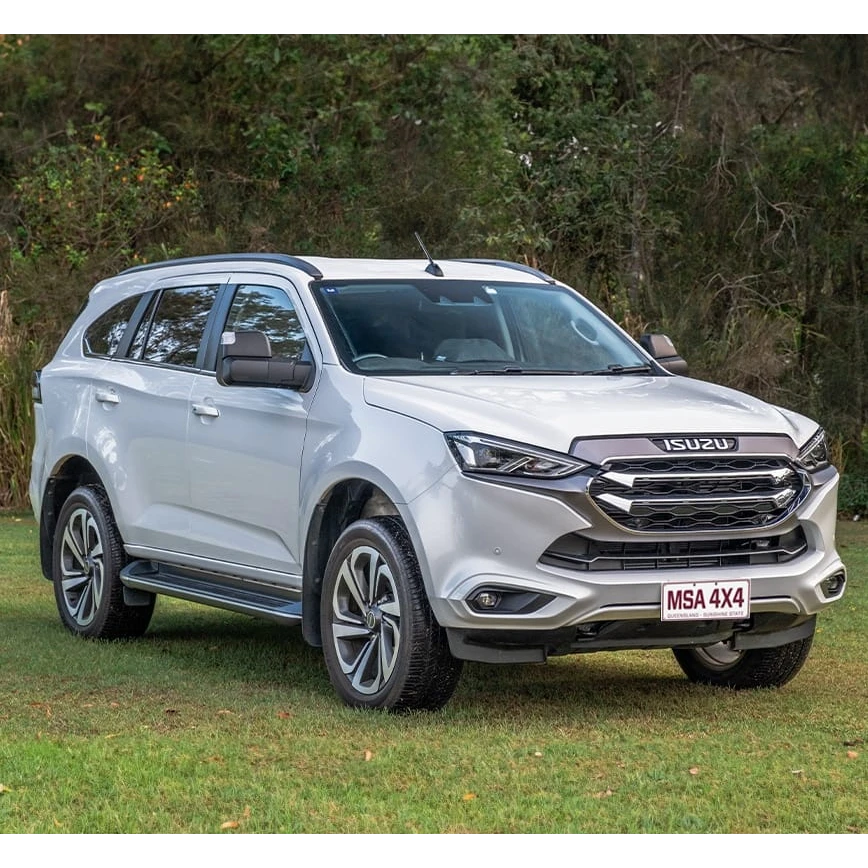 Silver Isuzu SUV parked on grass with trees in the background – DMAX & MUX MSA POWER FOLD Towing Mirrors