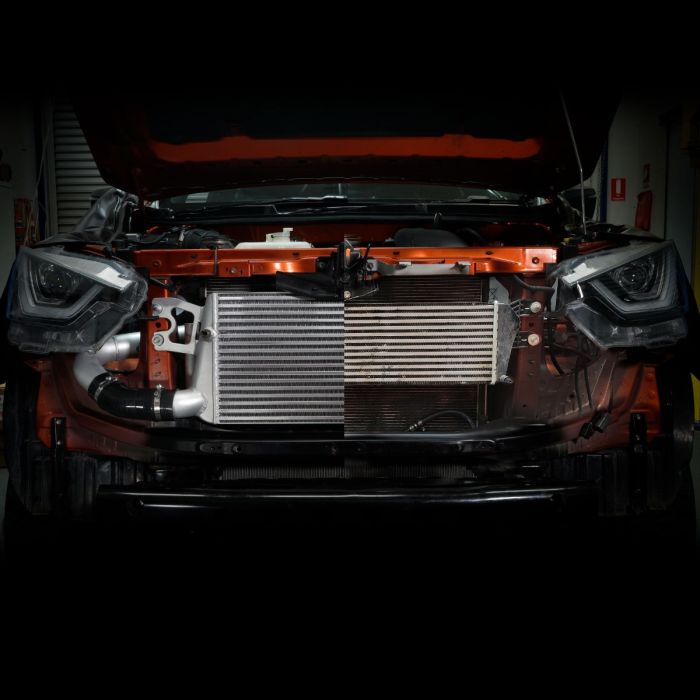 Car with open hood in a garage setting