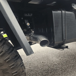 Close-up of a vehicle's exhaust system on a road.