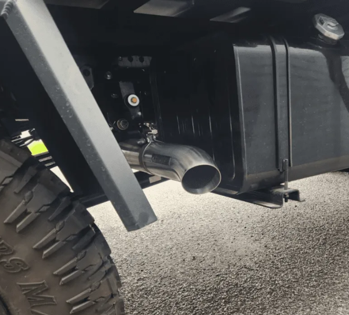 Close-up of a vehicle's exhaust system on a road.