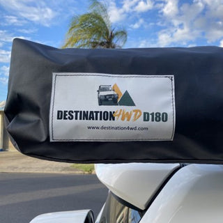 Black cover with 'Destination 4WD D180' logo on a vehicle, with palm trees and blue sky in the background.