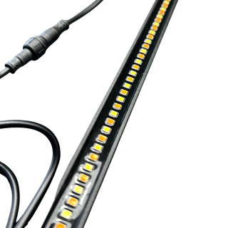 Close up of the Elevate dual colour LED strip light showing the alternating amber and white LEDs down the housing and the inline waterproof connector on the lead