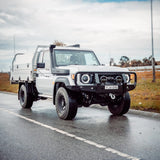 White Toyota truck on a road with a cloudy sky