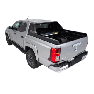Silver Mitsubishi Triton pickup truck with a black tonneau cover on a white background