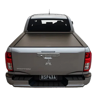 Back view of a silver Mitsubishi Triton pickup truck with a tonneau cover on a white background