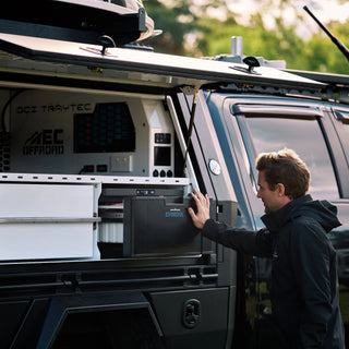 EvaKool 40L Platinum drawer fridge built into a ute canopy, with a man reaching for the drawer
