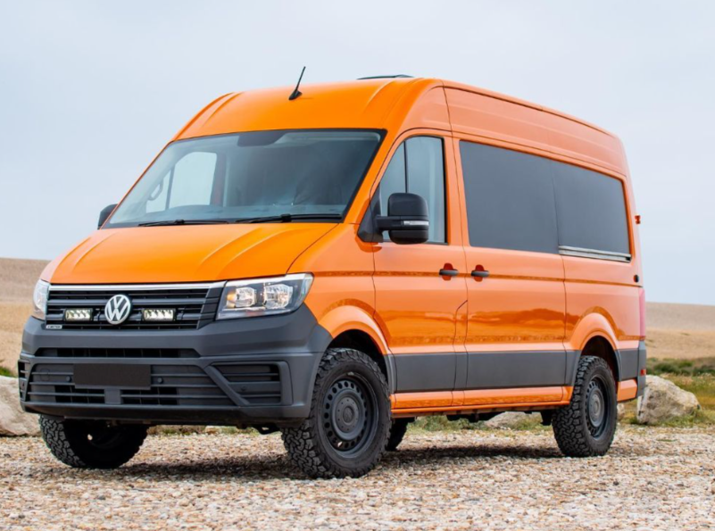 Orange Volkswagen van on a gravel road with a clear sky background with Lazer Lamps Grille Kit for VW Crafter (2017+)