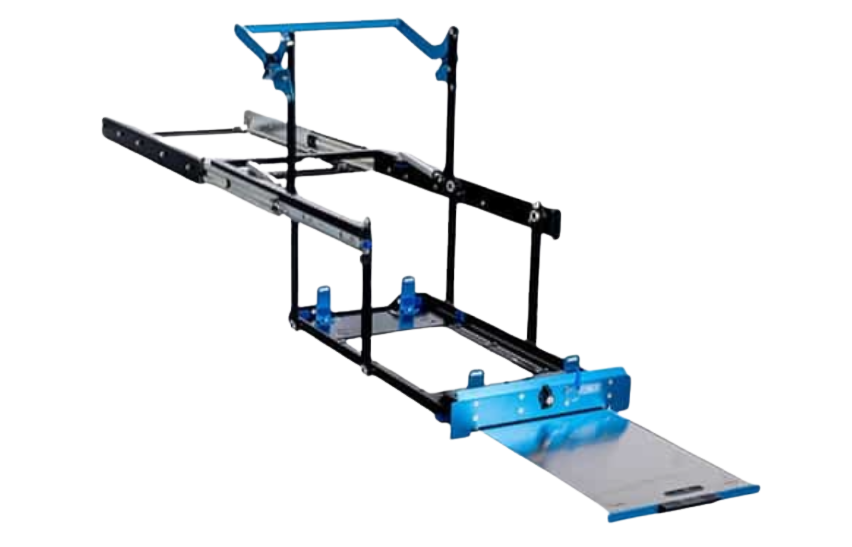 MSA drop slide with no fridge fitted, seen from above and behind with the sliding table extended, showing the drop-arm linkage, the four fridge stops on the tray and the blue front panel