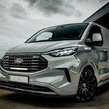 Silver Ford van parked on a road with a cloudy sky in the background with Ford Transit Custom (2024+) Grille Kit