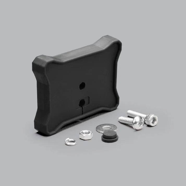 Flat mount with all its hardware laid out: the black moulded pad, a spring washer, a hex nut, a flat washer, a rubber blanking plug and two stainless socket screws