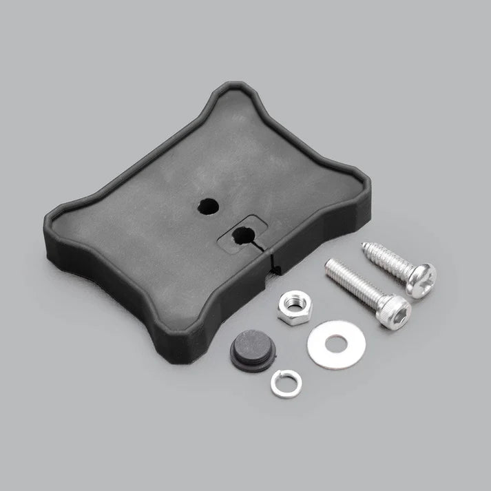Flat mount seen from above with its hardware, the mounting hole and cable slot visible in the top face beside the nut, washers, blanking plug and two screws