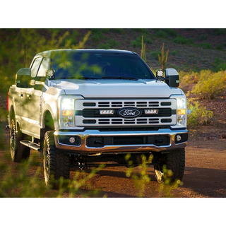 White Ford truck on a dirt road with desert landscape and Lazer Lamps Grille Kit – Ford F-250 & F-350 XL/XLT (2023+)