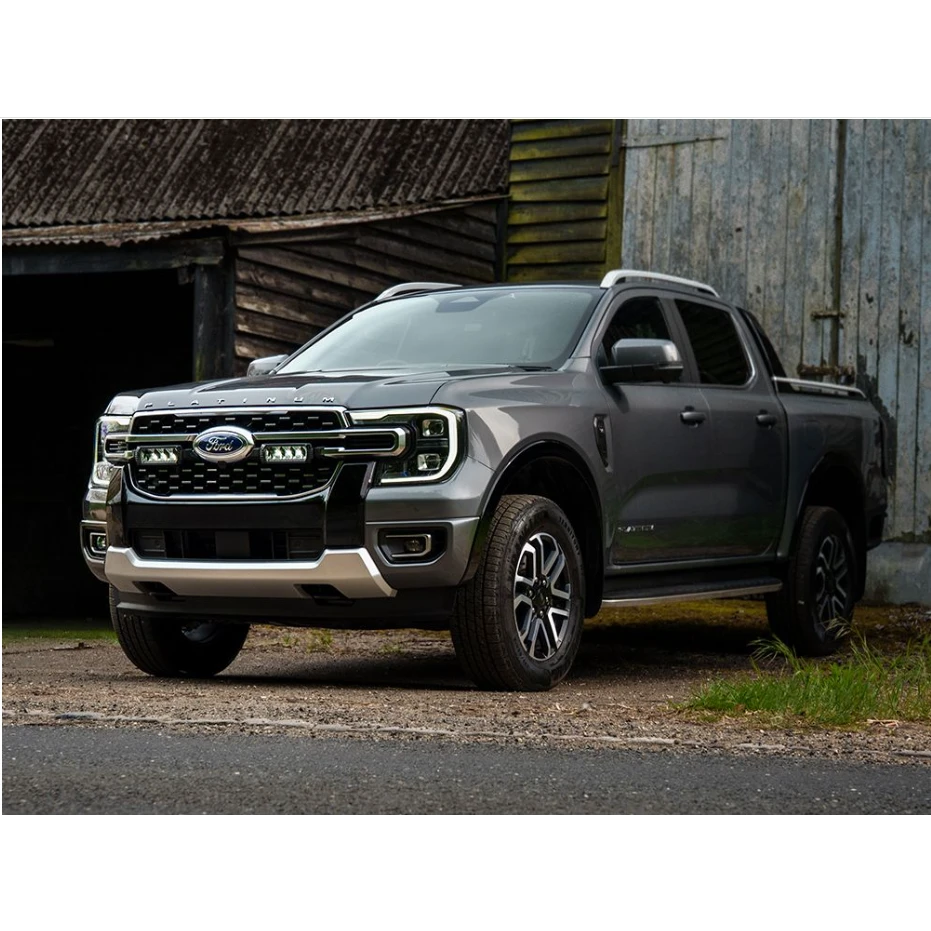Gray Ford truck parked in front of a rustic building with Lazer Lamps Grille Kit for Ford Ranger Platinum (2023+)