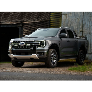 Gray Ford truck parked in front of a rustic building with Lazer Lamps Grille Kit for Ford Ranger Platinum (2023+)