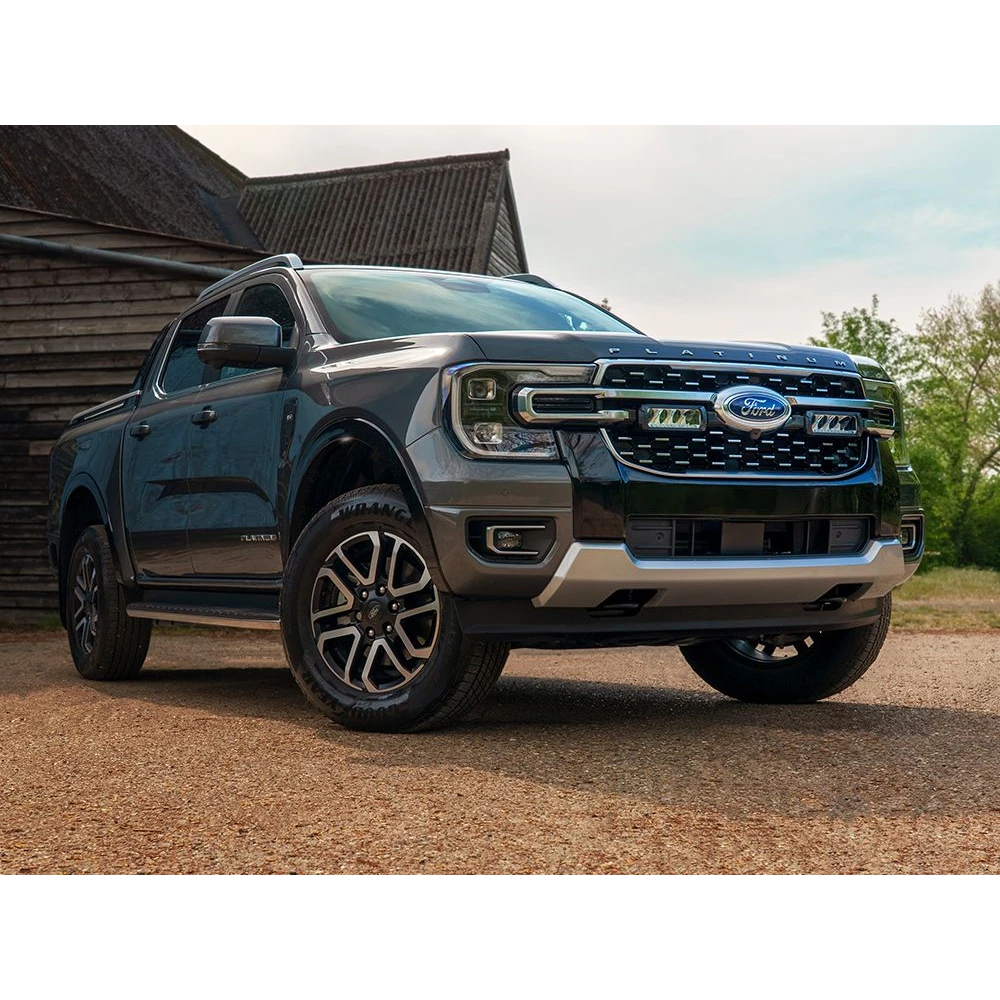 Ford Ranger Platinum (2023+) Grille Kit – Ford ute parked in front of a wooden building with trees in the background