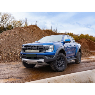 Ford Ranger Raptor (2023+) Grille Kit – blue Ford ute on a dirt road with a clear sky