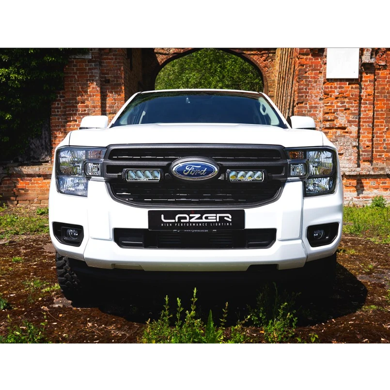 White Ford vehicle with LazerLamps Grille kit on a rustic background
