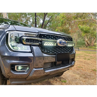 Ford vehicle grille with lazerLamps Grille Kit and trees in the background
