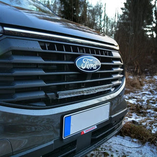 Close up of a Ford Transit Custom grille with the Lazer Glide light bar fitted using the grille kit