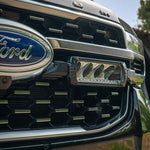 Close-up of a Ford vehicle grille with logo