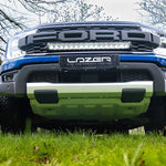 Front view of a Ford truck with Lazer performance lighting system on a grassy area.