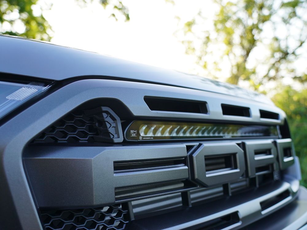 Close-up of a Ford Ranger Raptor grille with Lazer Lamps Grille Kit – Ford Ranger Raptor (2018–2022) installed, outdoors.