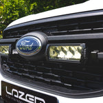 Close-up of a Ford vehicle grille with 'Lazer' branding.